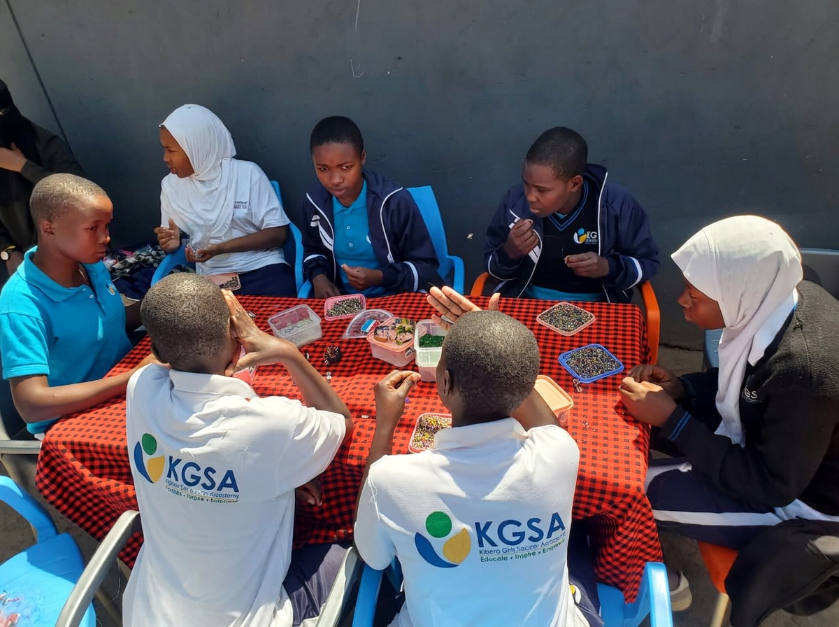 KGSA students beading together around a table during a business club session