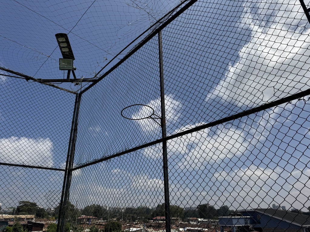 Netball hoop and safety netting on the KGSA rooftop court