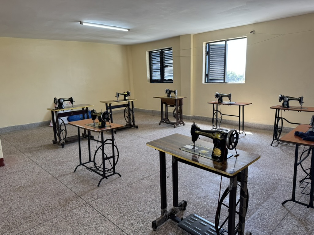 Sewing machines lined up in the KGSA tailoring workshop