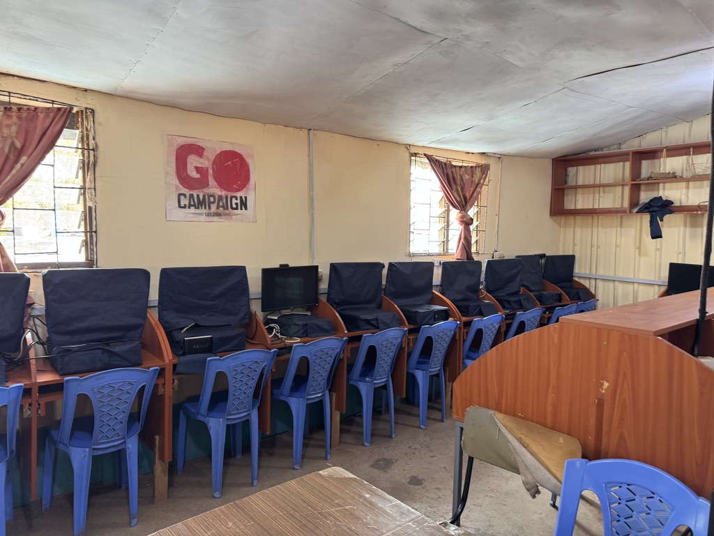 Rows of computer workstations and chairs in a KGSA classroom
