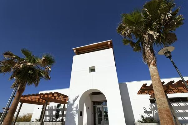 El Corazon venue exterior with white tower entrance and palm trees