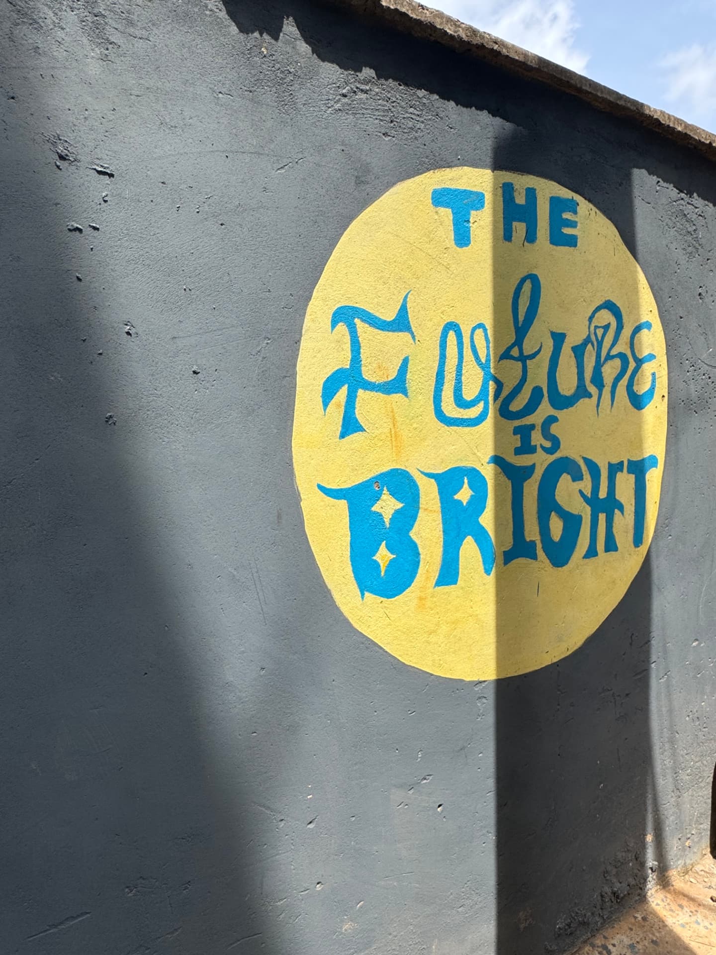 A mural on the KGSA campus wall reading "The Future is Bright"